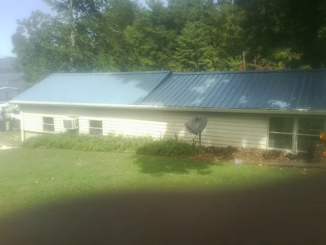Blue metal roof running the length of a single story home in Etna
